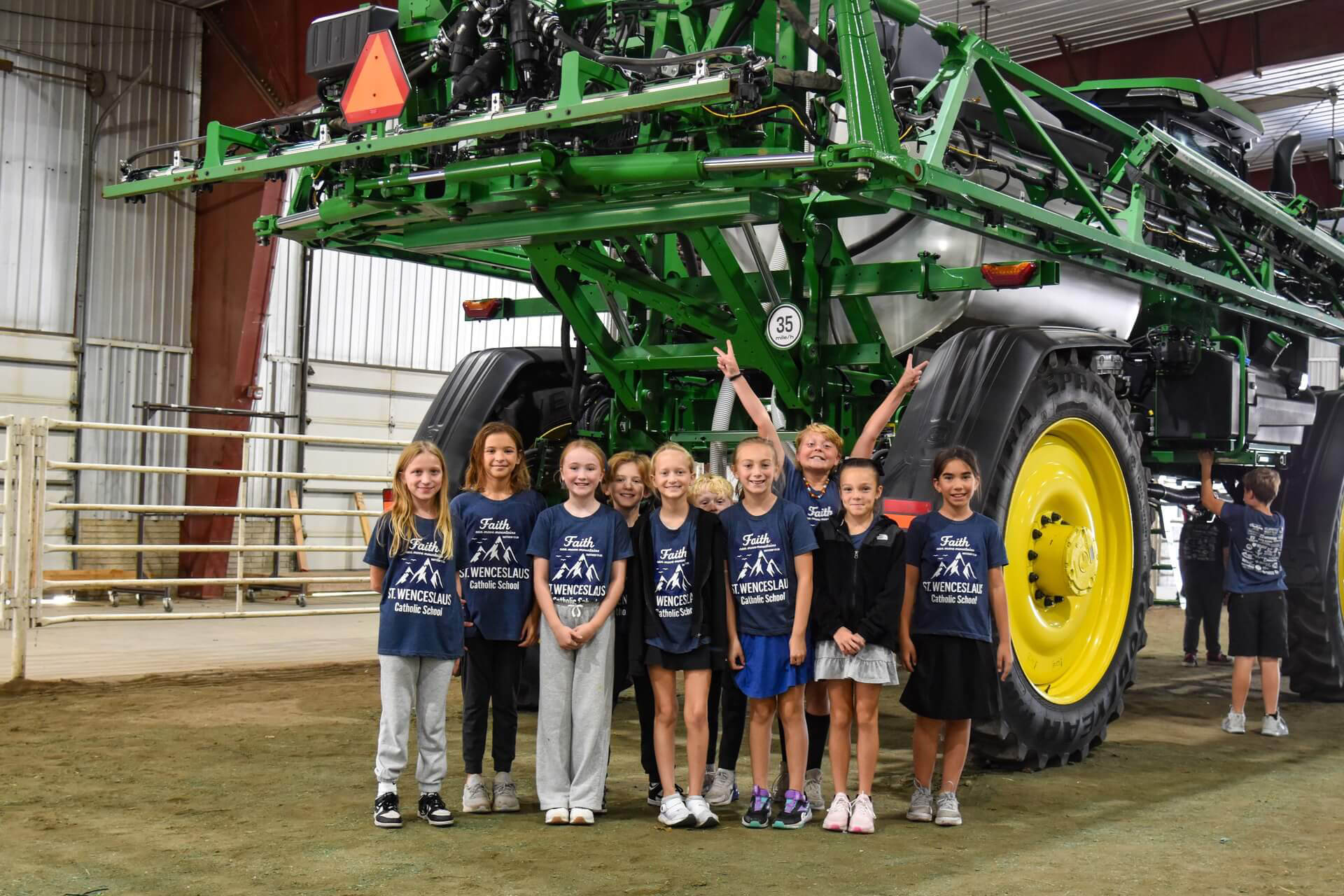 Students standing in front of John Deere sprayer at Saunders County Ag Literacy Festival