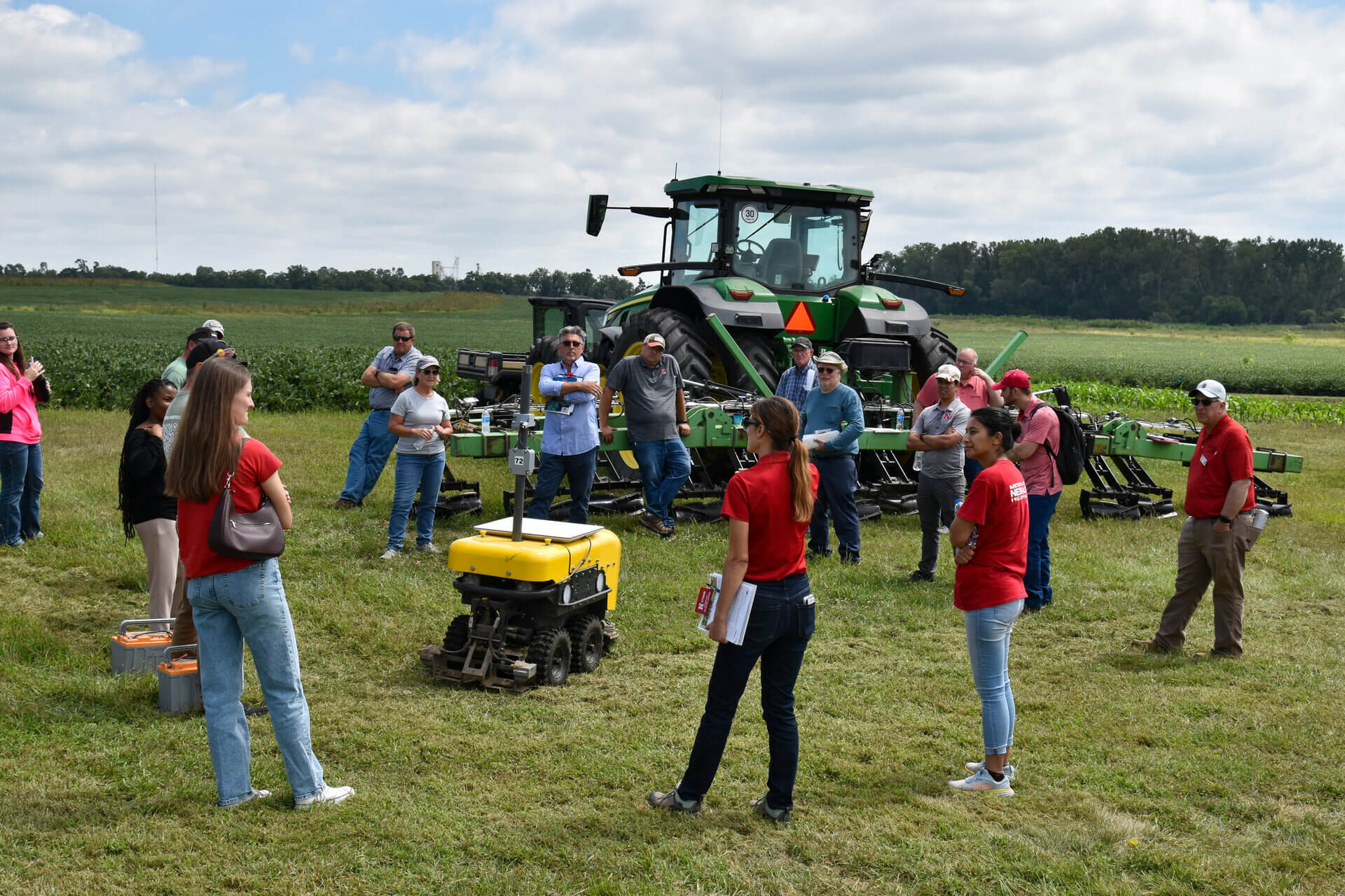 A group gathers to learn in a field presentation a the Crop Production and Soil Health Clinic