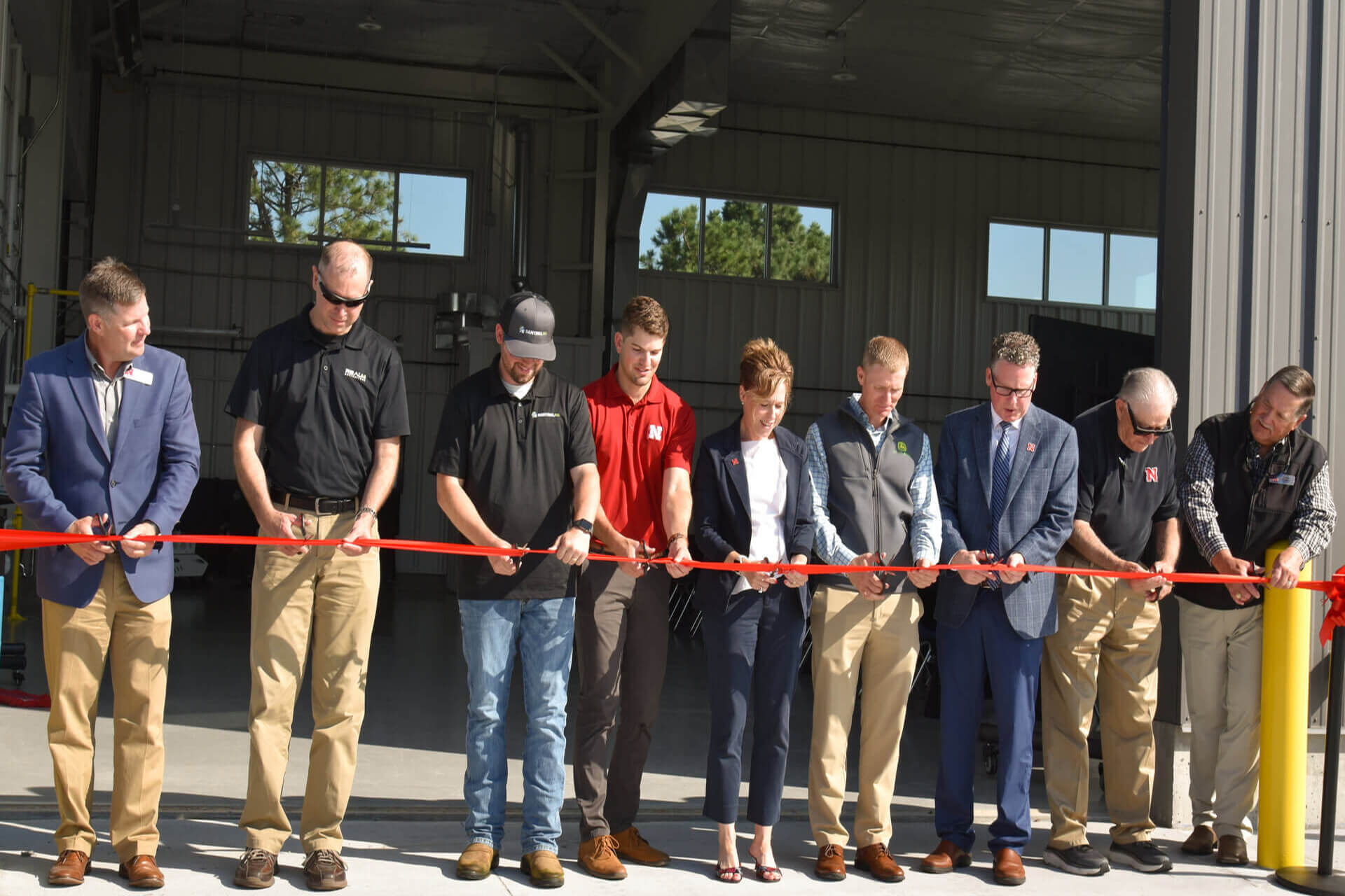 Cutting the ribbon in front of NFARMS building 