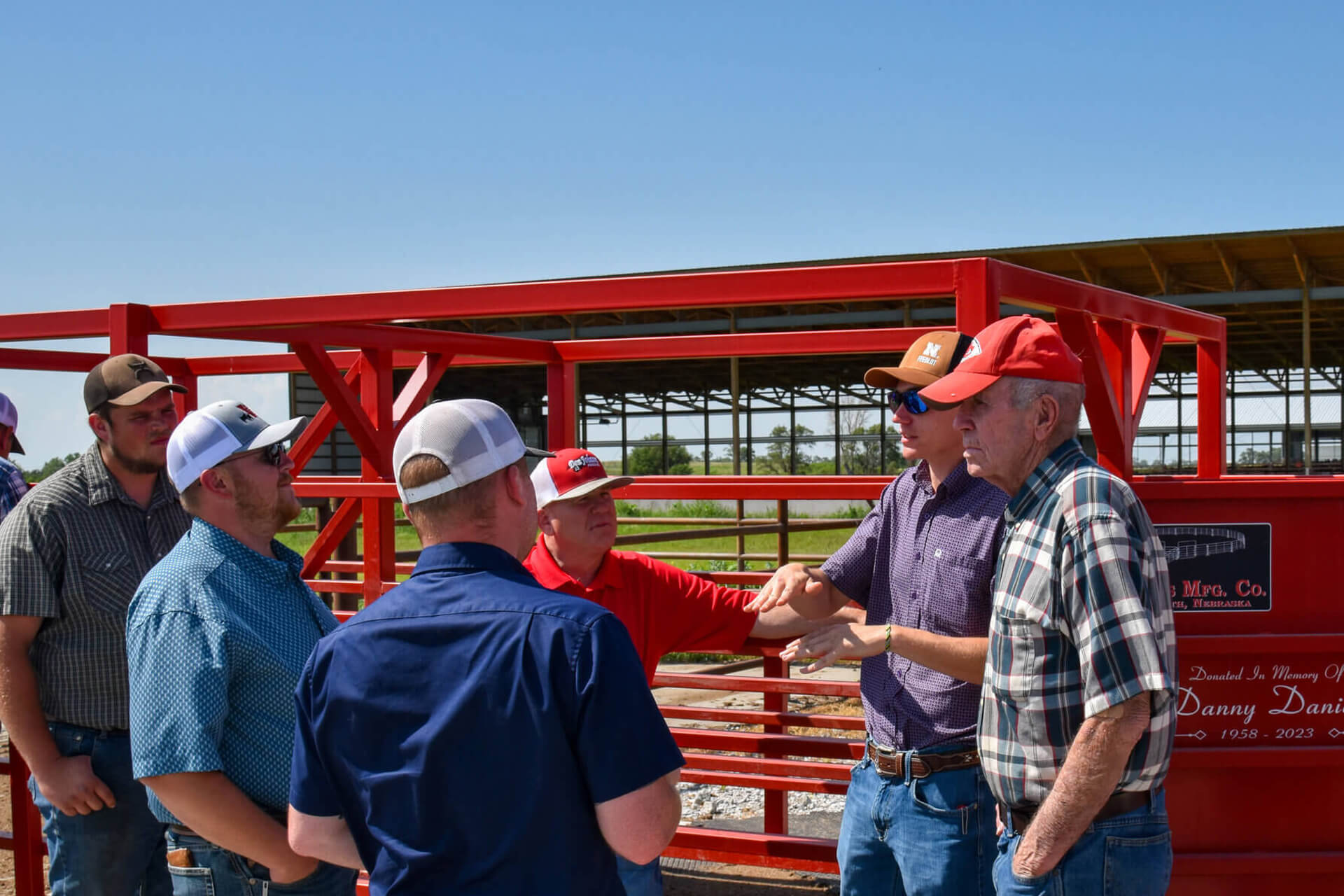 Platte Valley cattlemen group conversing by loadout chute at KFIC