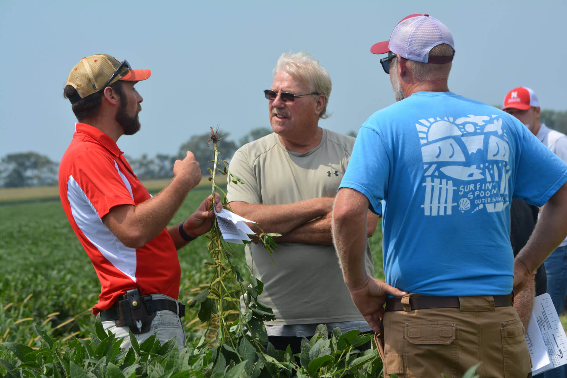 Growers and On-farm research network extension specialists in soybean field during the Soybean Management Field Day at ENREEC