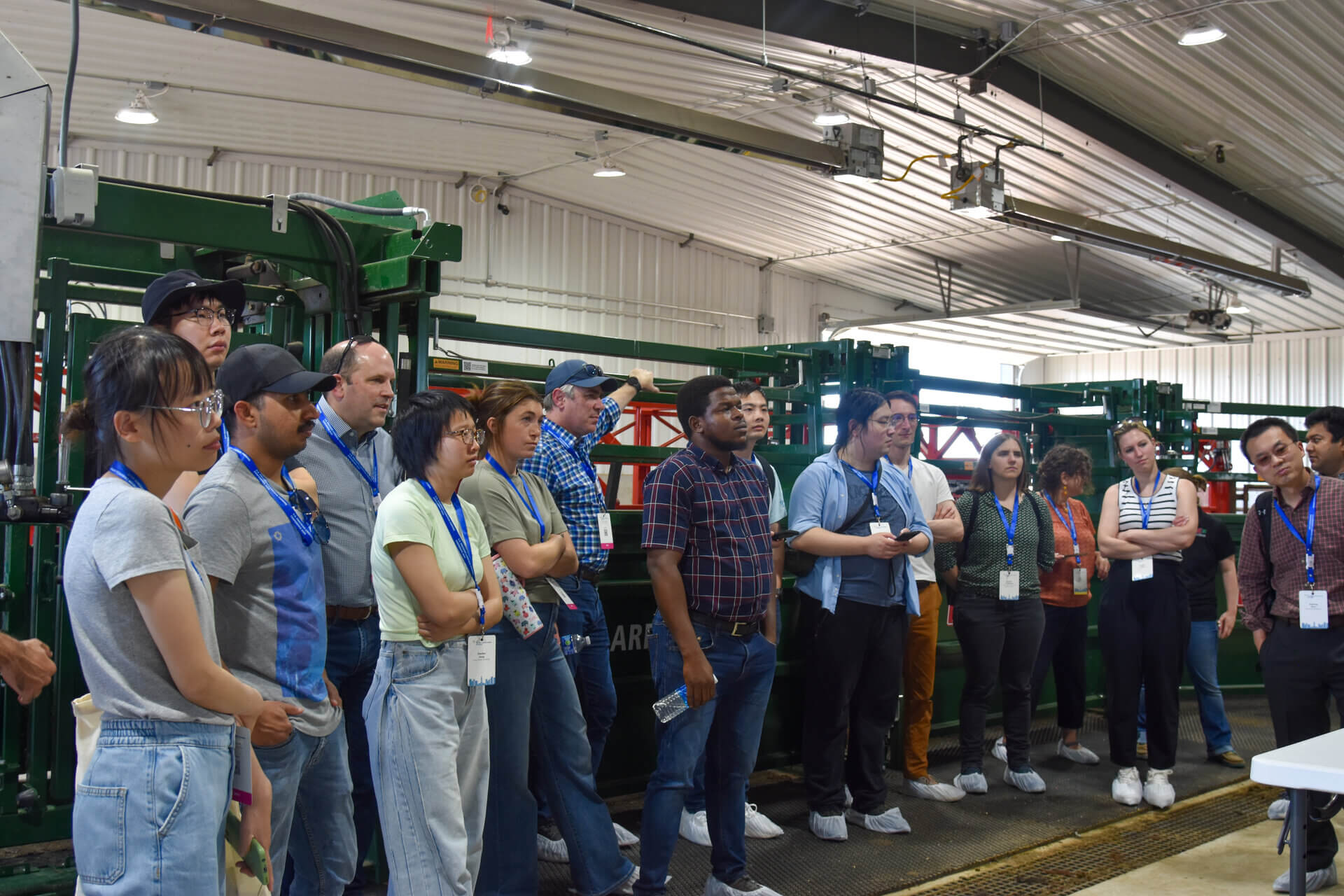 Participants listen to animal husbandry presentation in KFIC handling facility 