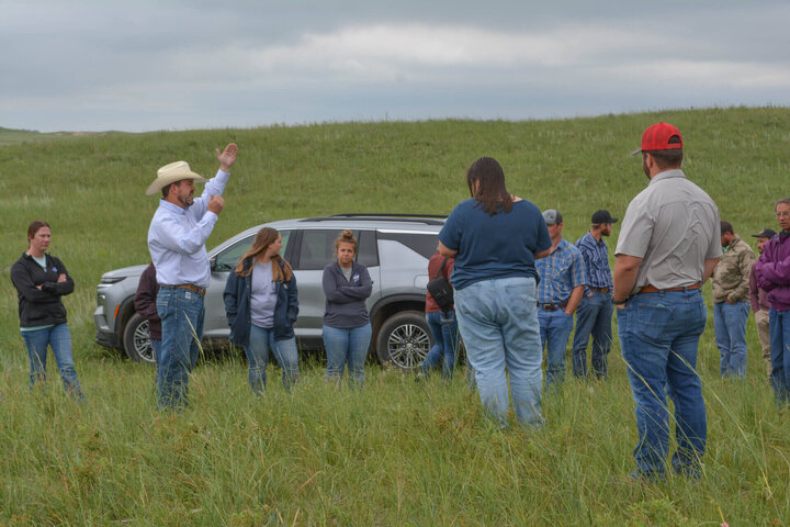 Presenter and producers grouped in Barta Brothers Ranch pasture during field day.