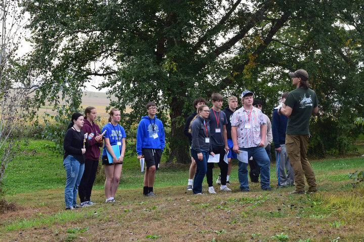 Students gather around presenter for outside presentation during Haskell Ag Lab Biology in Action Day.