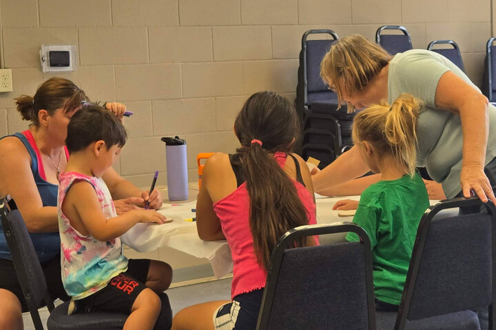 Youth working on hands-on activities at one of the group tables.